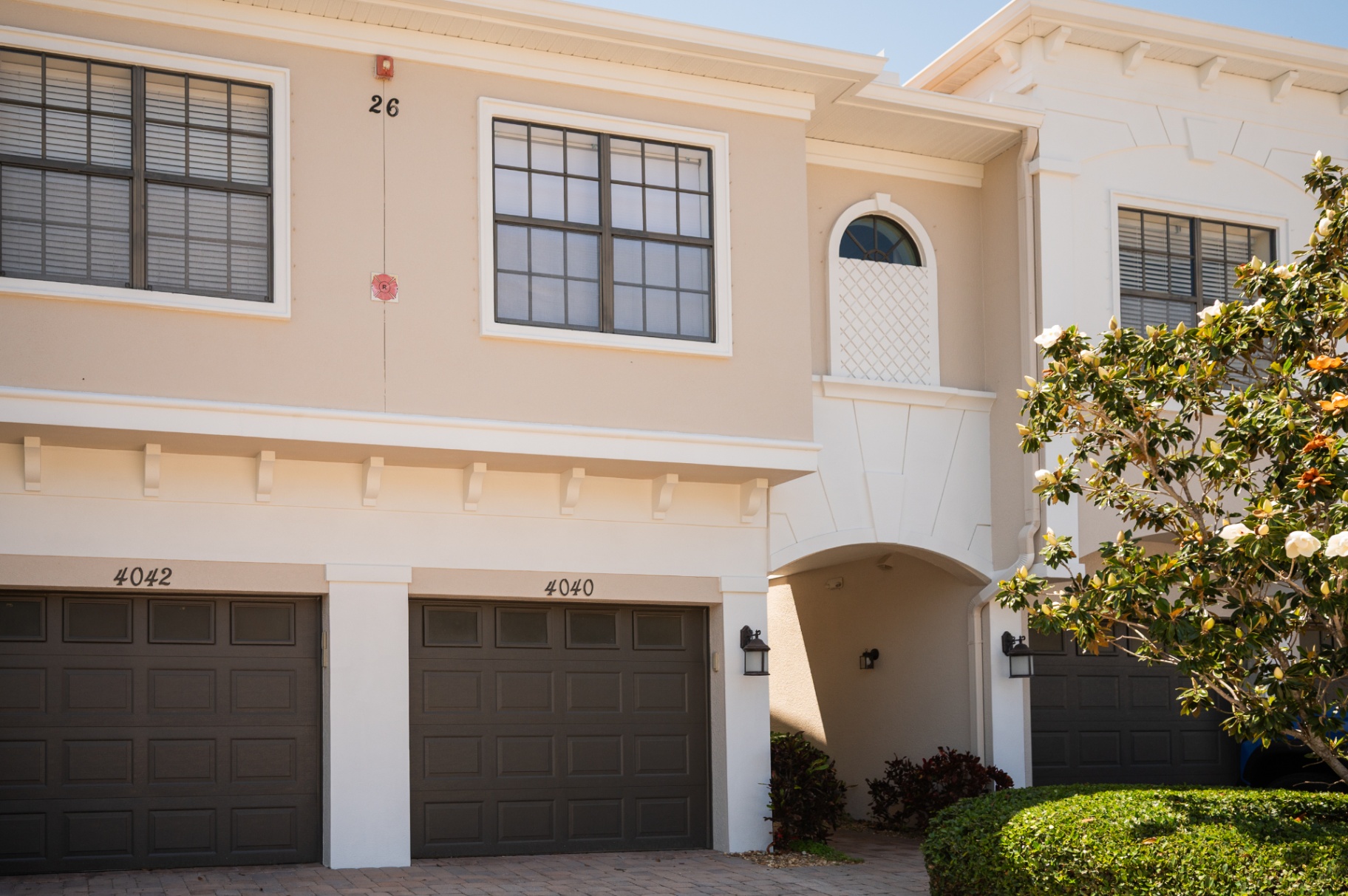 Front exterior of the furnished Bradenton townhome with private garage and covered entry